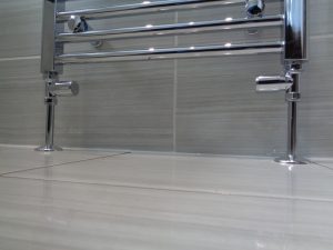 Chrome heating pipes comming out of the floor