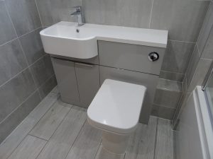 Bathroom fitted with covered and hidden soil pipe