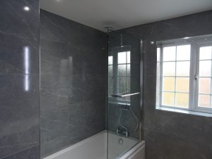 Fully tiled family bathroom with shower bath in Kenilworth
